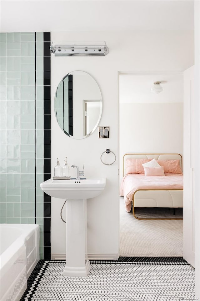 bathroom featuring  shower combination, baseboards, and ensuite bathroom