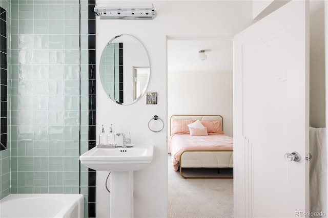 bathroom with  shower combination and a sink