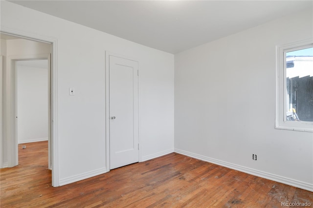 unfurnished bedroom featuring hardwood / wood-style flooring