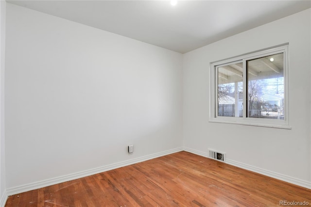 unfurnished room featuring hardwood / wood-style floors