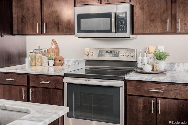 kitchen featuring stainless steel appliances and dark brown cabinetry