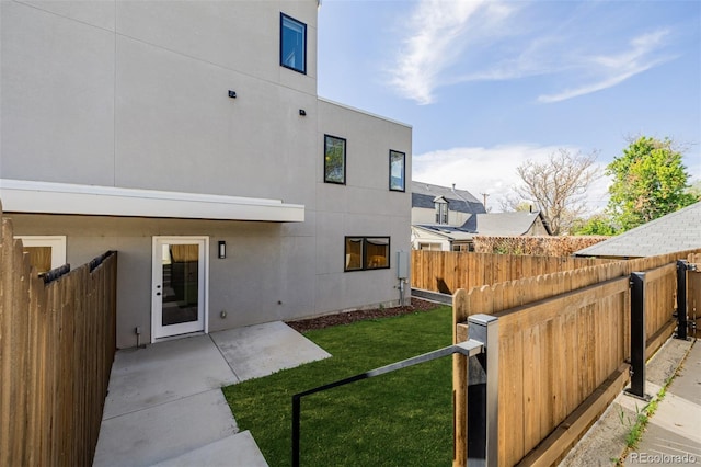 rear view of property featuring stucco siding