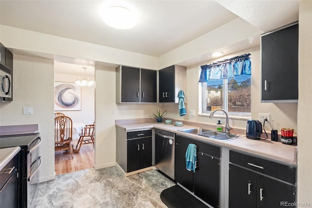 kitchen with stainless steel appliances, a sink, baseboards, light countertops, and dark cabinetry