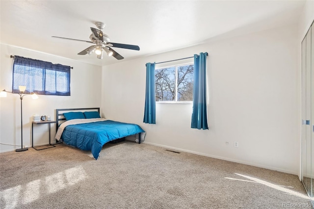 bedroom featuring carpet floors, baseboards, multiple windows, and visible vents