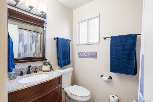 bathroom with toilet and vanity