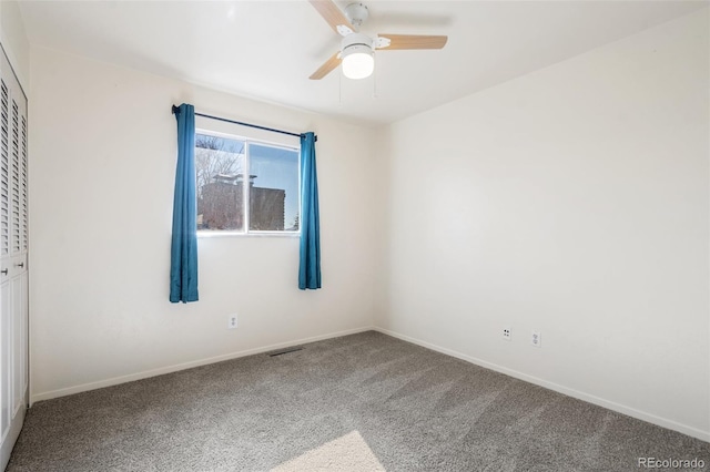 interior space with ceiling fan, visible vents, baseboards, a closet, and carpet