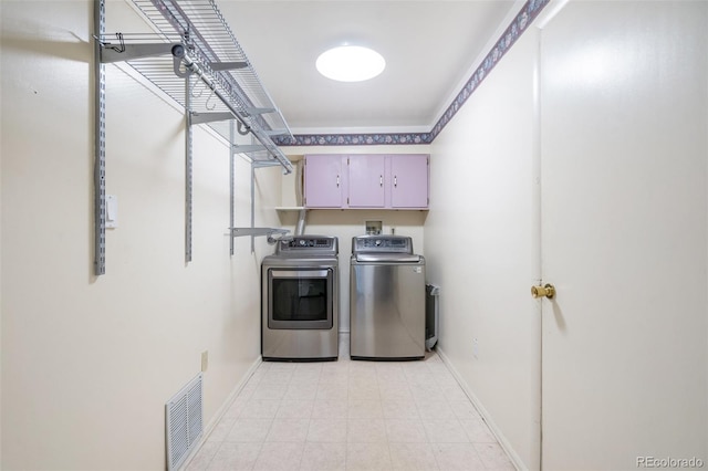 clothes washing area featuring cabinet space, washing machine and dryer, visible vents, and baseboards