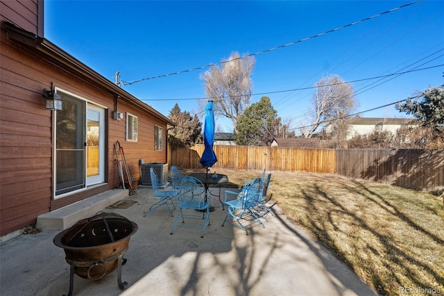 view of patio / terrace with entry steps, a fenced backyard, cooling unit, and outdoor dining space