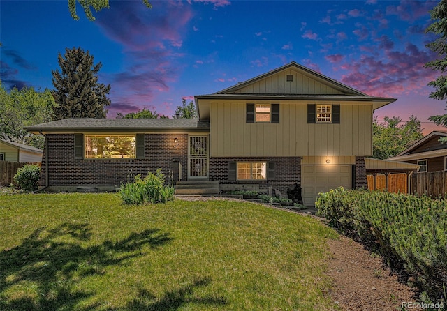 8346 W Woodard Dr, Lakewood, CO 80227 - split level home with brick siding and a garage