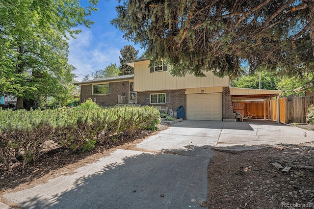 8346 W Woodard Dr, Lakewood, CO 80227 - split level home featuring brick siding, concrete driveway, a garage, and a carport