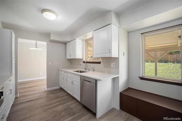 8346 W Woodard Dr, Lakewood, CO 80227 - kitchen featuring dishwasher, a sink, white cabinetry, and light countertops