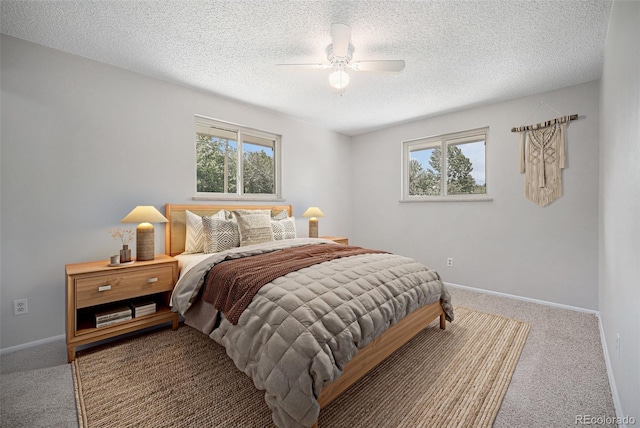8346 W Woodard Dr, Lakewood, CO 80227 - bedroom featuring multiple windows, carpet, a textured ceiling, and baseboards