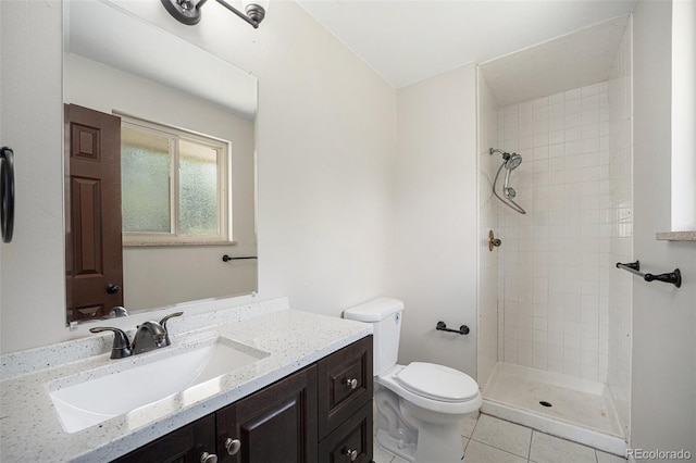 8346 W Woodard Dr, Lakewood, CO 80227 - bathroom with toilet, vanity, tiled shower, and tile patterned flooring