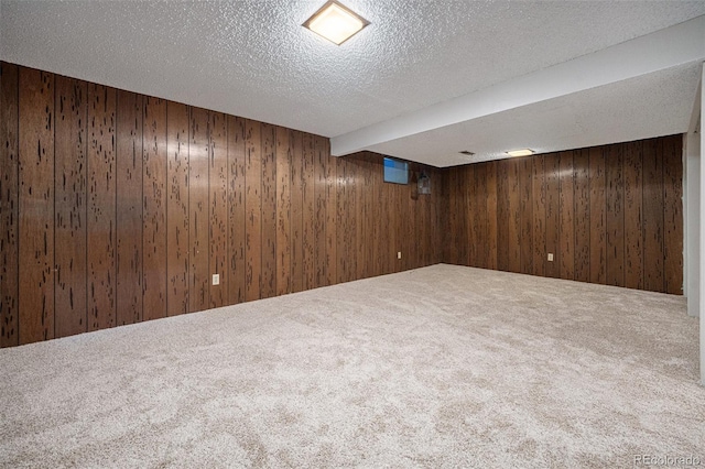 8346 W Woodard Dr, Lakewood, CO 80227 - finished below grade area featuring wood walls, carpet flooring, and a textured ceiling
