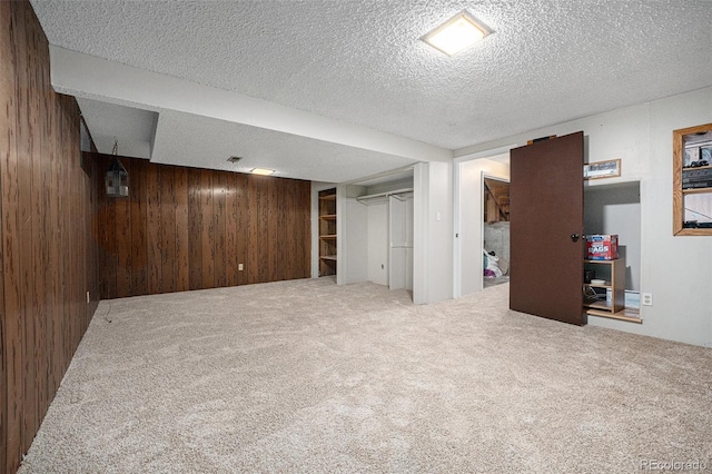 8346 W Woodard Dr, Lakewood, CO 80227 - finished basement with wooden walls, carpet floors, and a textured ceiling