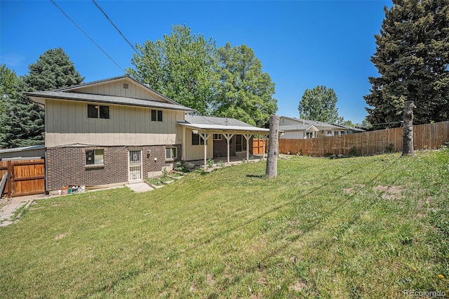 8346 W Woodard Dr, Lakewood, CO 80227 - back of property featuring brick siding and a patio