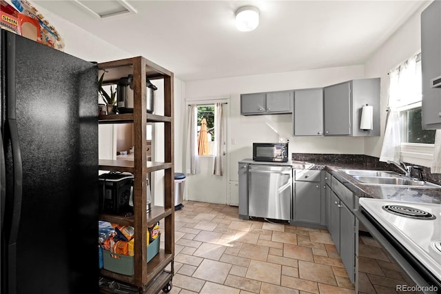 kitchen with dishwasher, sink, electric range, and gray cabinetry