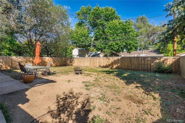 view of yard with a fire pit and a patio