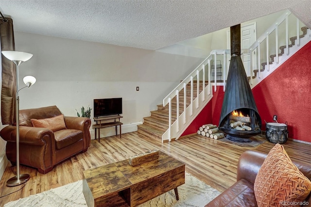 living room with a textured ceiling and hardwood / wood-style flooring