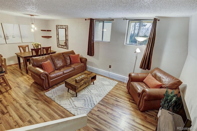 living room with light hardwood / wood-style floors and a textured ceiling