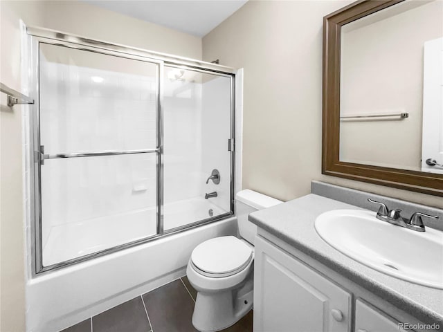 full bathroom featuring tile patterned flooring, vanity, combined bath / shower with glass door, and toilet