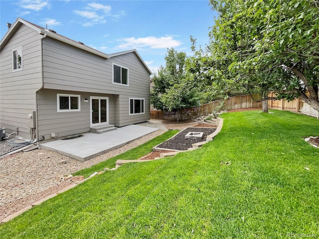 rear view of house with a patio area and a lawn