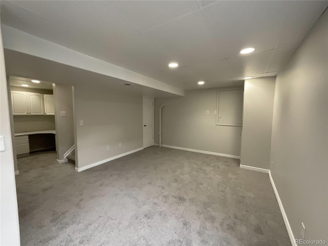 basement featuring light carpet