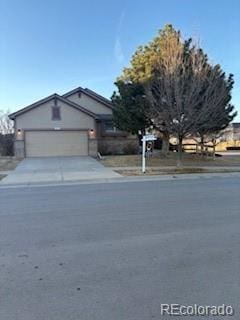 view of front of house with concrete driveway and an attached garage