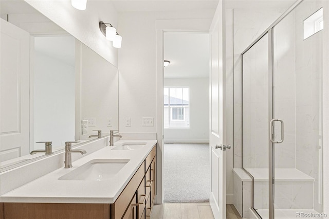 20665 E 57th Dr, Aurora, CO 80019 - bathroom with a stall shower, double vanity, and baseboards