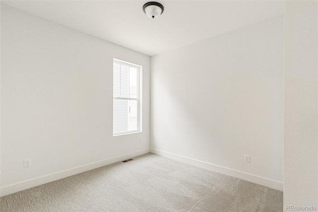 20665 E 57th Dr, Aurora, CO 80019 - spare room featuring light carpet and baseboards