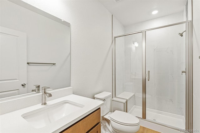 20665 E 57th Dr, Aurora, CO 80019 - bathroom featuring a stall shower, toilet, and vanity