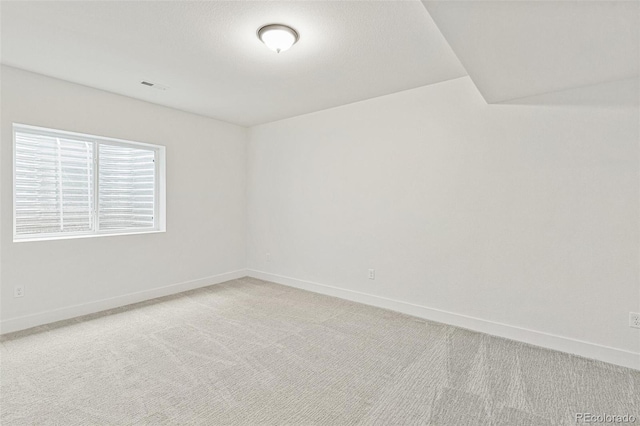 20665 E 57th Dr, Aurora, CO 80019 - unfurnished room with baseboards and light carpet