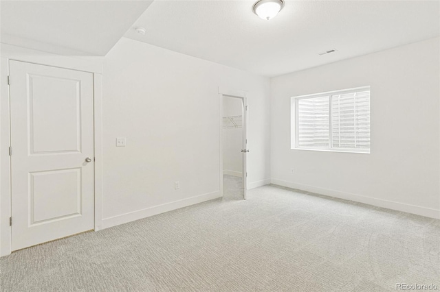 20665 E 57th Dr, Aurora, CO 80019 - unfurnished bedroom featuring light carpet, baseboards, a spacious closet, and a closet