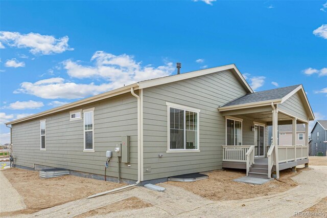 20665 E 57th Dr, Aurora, CO 80019 - view of side of home featuring a deck