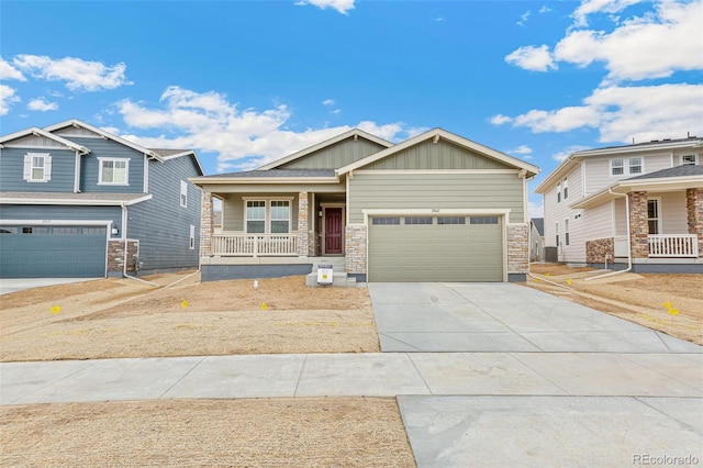 20665 E 57th Dr, Aurora, CO 80019 - craftsman house with covered porch, board and batten siding, concrete driveway, an attached garage, and stone siding
