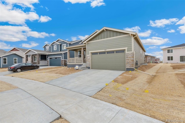 20665 E 57th Dr, Aurora, CO 80019 - craftsman house with board and batten siding, concrete driveway, a residential view, and stone siding