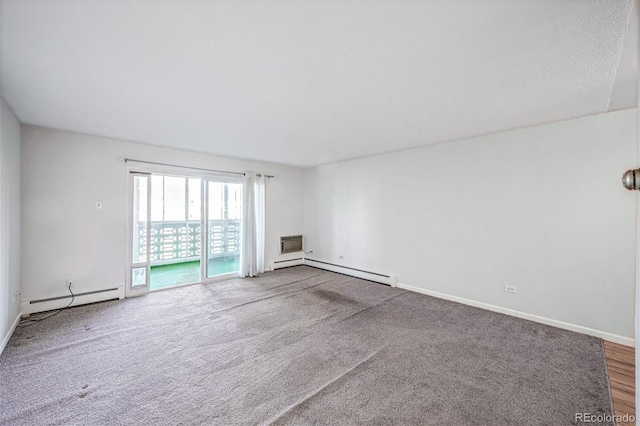 spare room with carpet, a textured ceiling, an AC wall unit, and a baseboard radiator