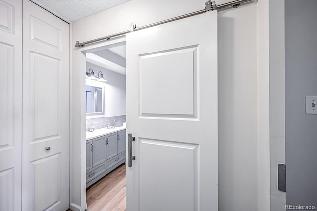 9340 E Center Ave Unit 8B, Denver, CO 80247 - bathroom featuring vanity, wood finished floors, and a textured ceiling