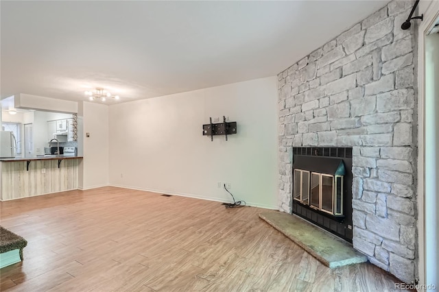 unfurnished living room with a fireplace and hardwood / wood-style flooring