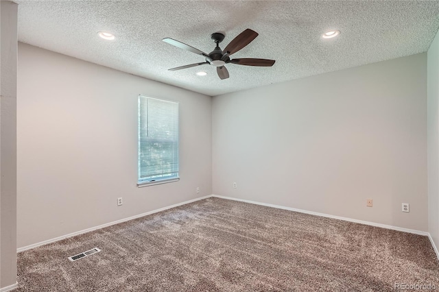 empty room with ceiling fan, a textured ceiling, and carpet