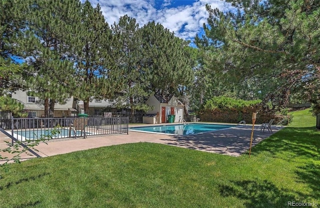 view of swimming pool featuring a lawn and a patio