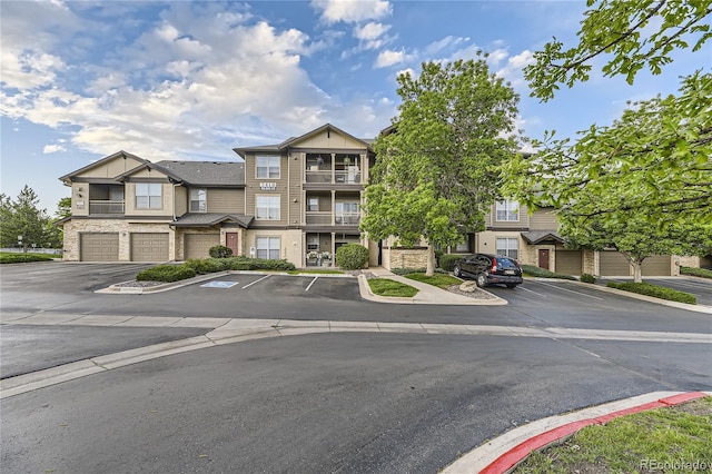 7418 S Quail Cir Unit 1312, Littleton, CO 80127 - view of front of house featuring uncovered parking and stone siding