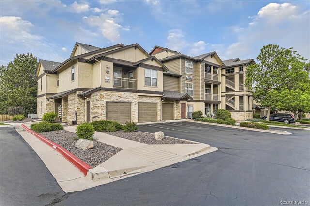 7418 S Quail Cir Unit 1312, Littleton, CO 80127 - multi unit property with stone siding, a garage, and stucco siding