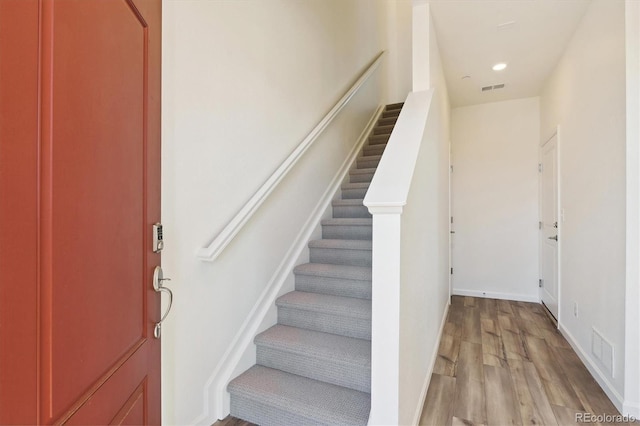 stairs with wood-type flooring