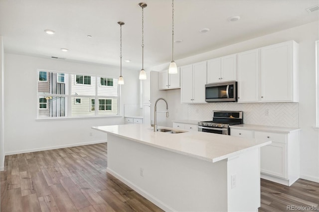 kitchen with white cabinetry, an island with sink, and stainless steel appliances