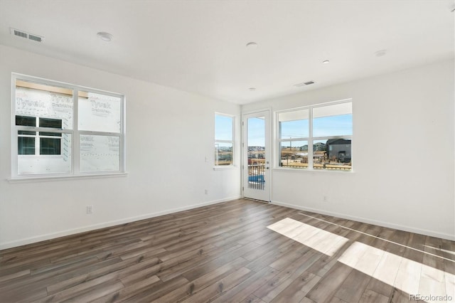 unfurnished room with dark hardwood / wood-style floors