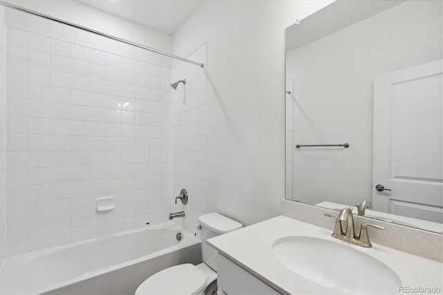 full bathroom with toilet, vanity, and tiled shower / bath