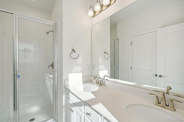 bathroom featuring vanity and a shower with door