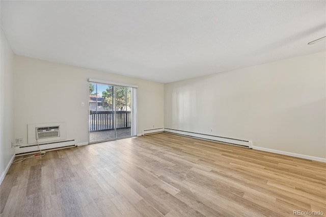7020 E Girard Ave Unit 109, Denver, CO 80224 - unfurnished room featuring baseboard heating, wood finished floors, and a wall unit AC