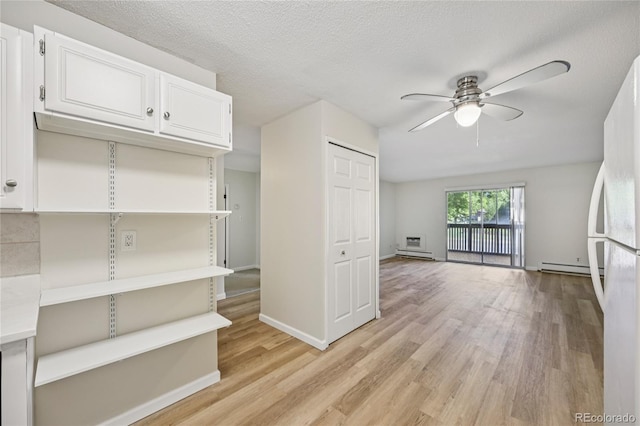 7020 E Girard Ave Unit 109, Denver, CO 80224 - interior space featuring ceiling fan, light wood-style flooring, and baseboard heating